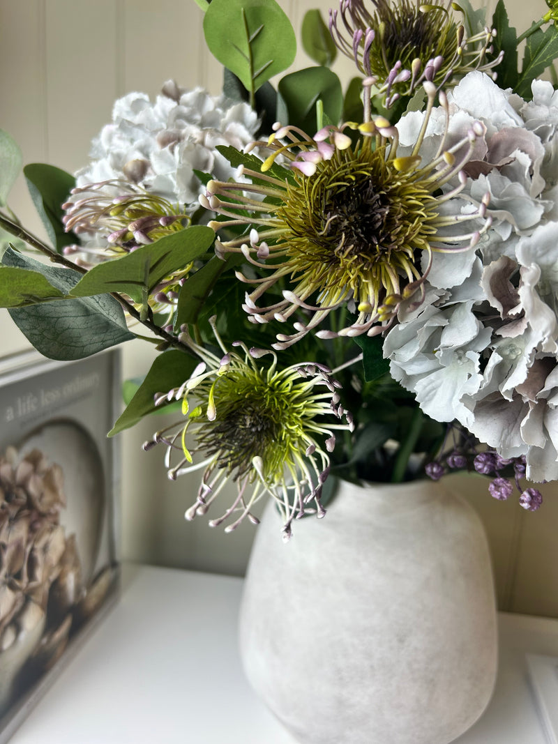 Green and purple protea stem head