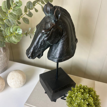 Black carved horse head on base stand