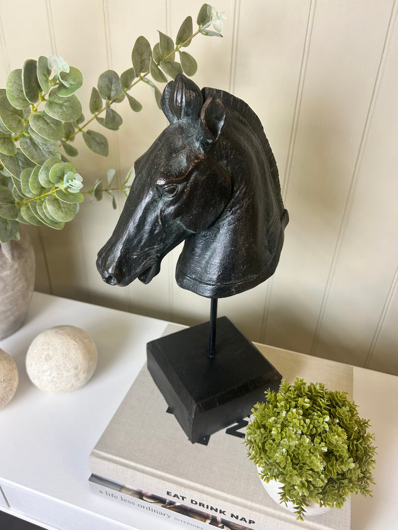 Black carved horse head on base stand