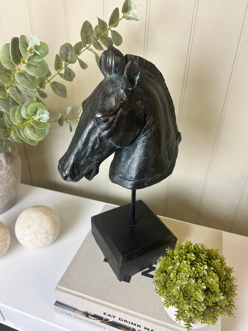 Black carved horse head on base stand