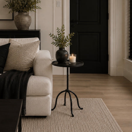 Black metal side table with pedestal leg