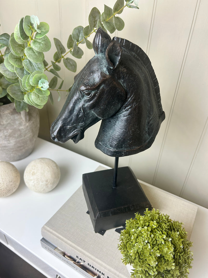 Black carved horse head on base stand