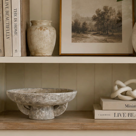 Round rustic stone bowl on foot base