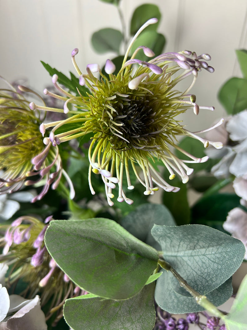Green and purple protea stem head