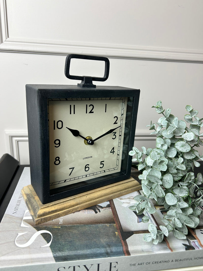 Black wooden based metal clock