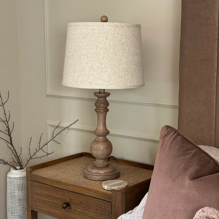 Tall wooden turned lamp with linen shade