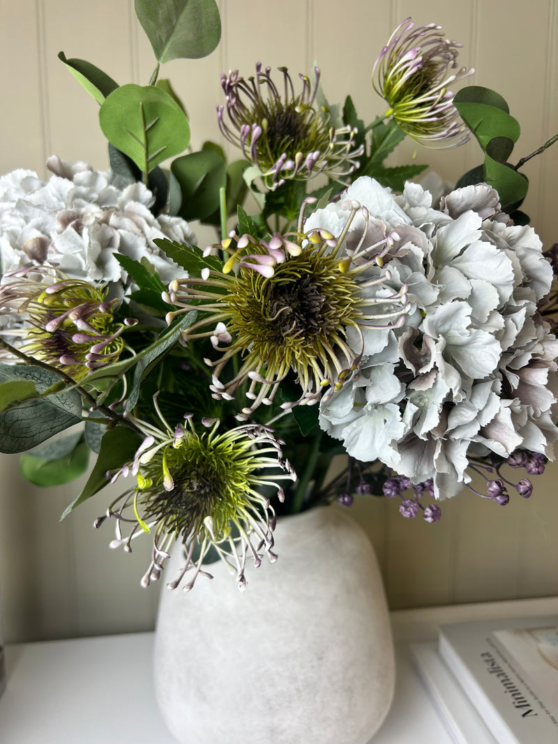 Green and purple protea stem head