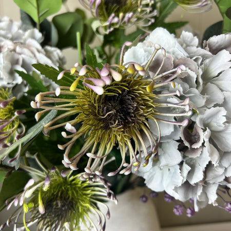 Green and purple protea stem head
