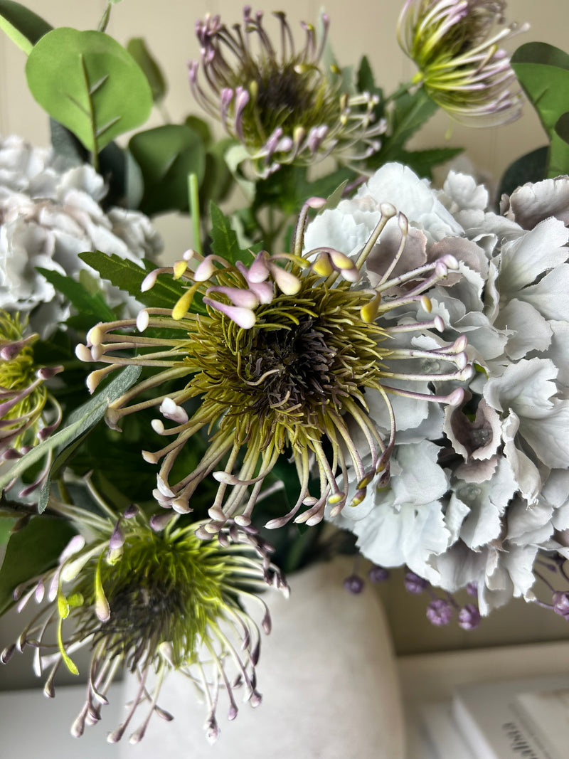 Green and purple protea stem head