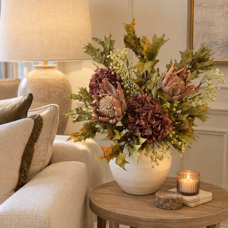 Mocha arrangement with artichokes heads hydrangea and green foliage
