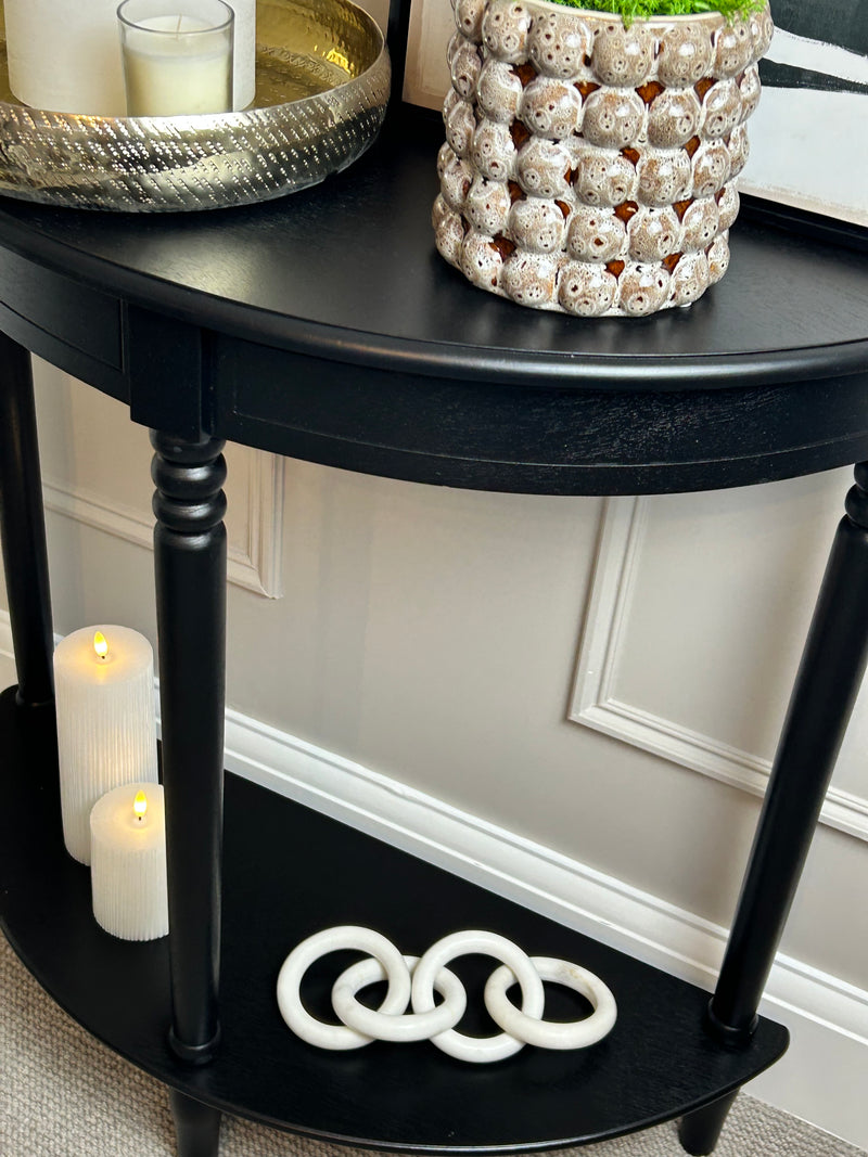 Black half moon table with turned legs