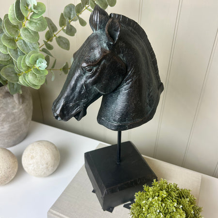 Black carved horse head on base stand