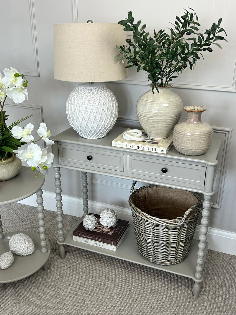 Neutral taupe console table with textured beaded legs