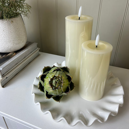 Ruffled white ceramic candle plate