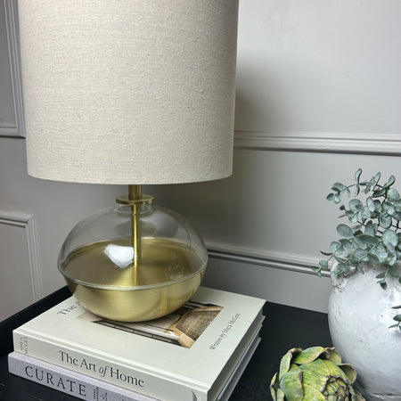 Gold glass round squat lamp with linen shade