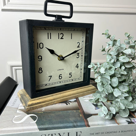 Black wooden based metal clock