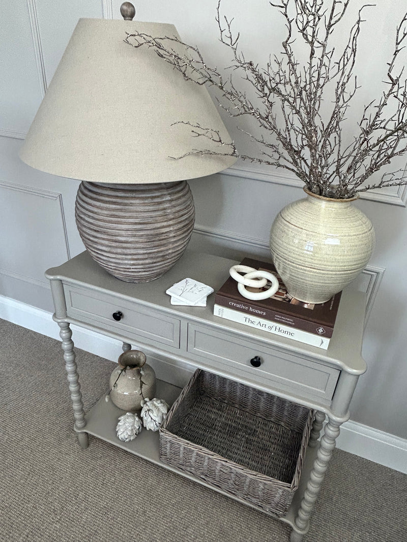 Neutral taupe console table with textured beaded legs