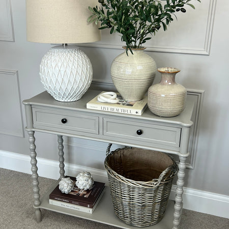 Neutral taupe console table with textured beaded legs