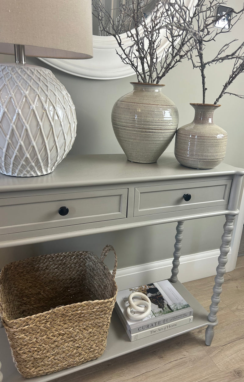 Neutral taupe console table with textured beaded legs