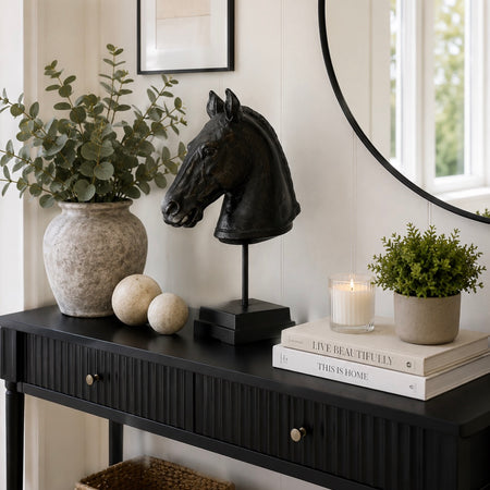 Black carved horse head on base stand