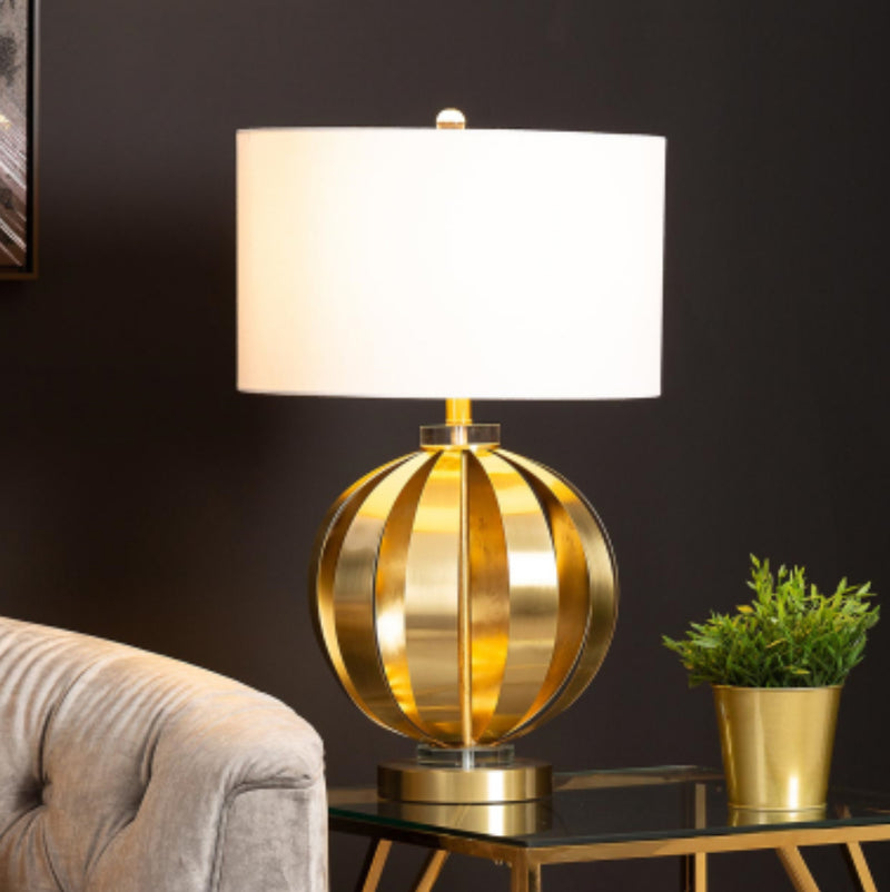 Gold metal round chunky lamp with white shade