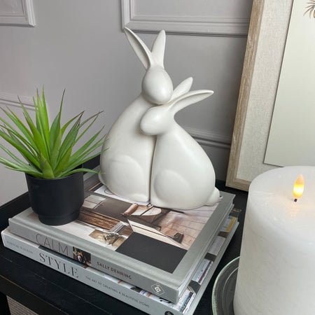 White ceramic hugging rabbits