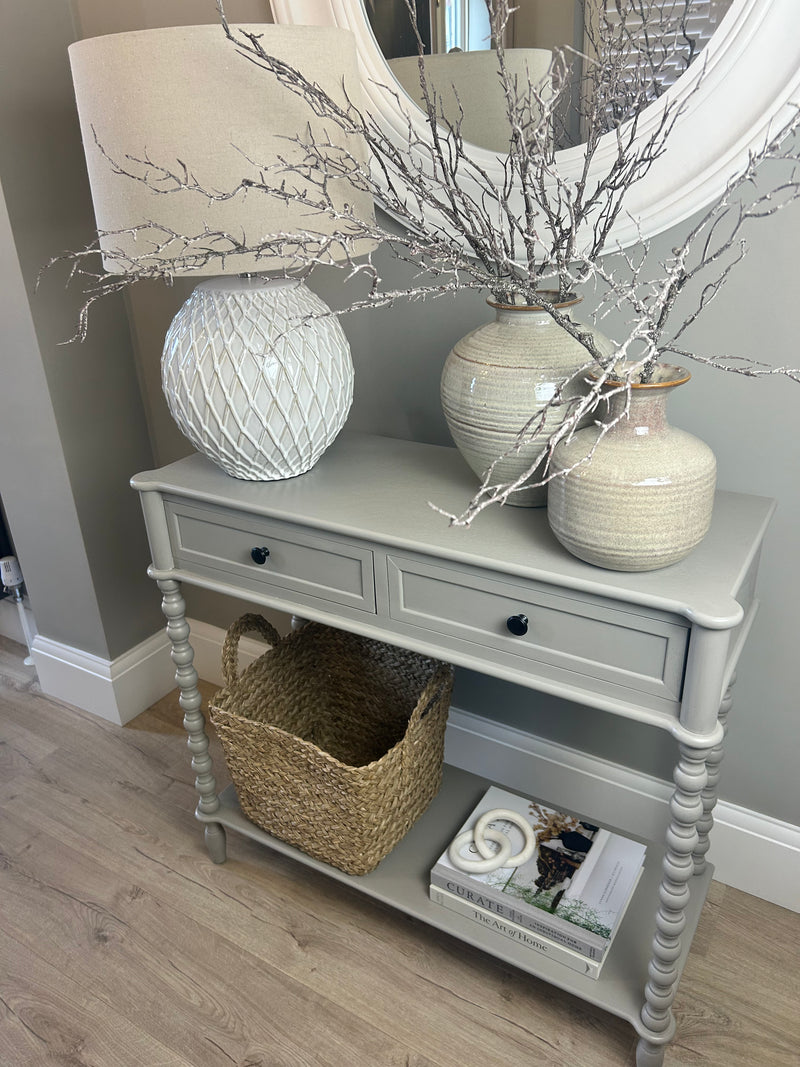 Neutral taupe console table with textured beaded legs