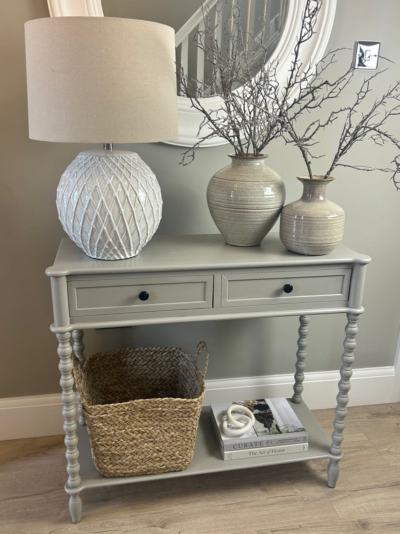 Neutral taupe console table with textured beaded legs