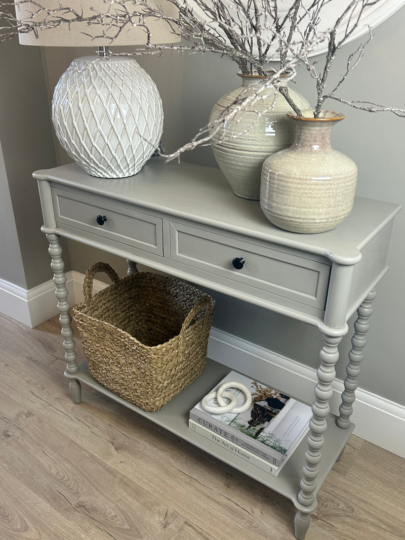 Neutral taupe console table with textured beaded legs