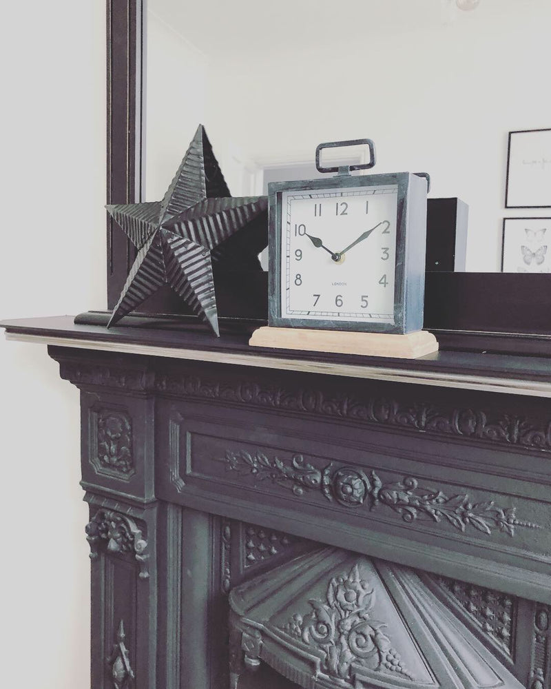 Black wooden based metal clock