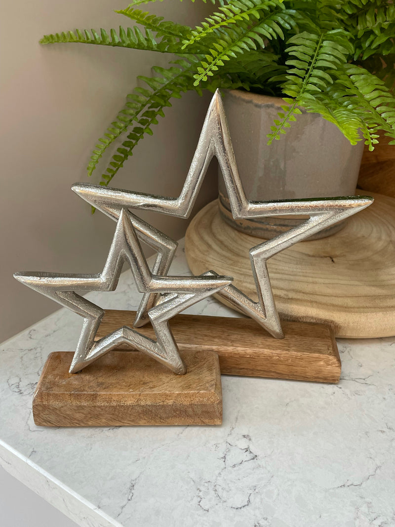 Large aluminium star on wood block