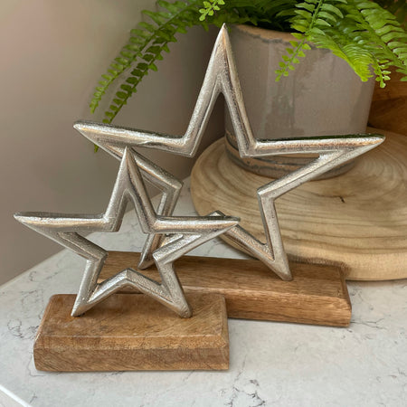 Medium aluminium star on wood block 22cm