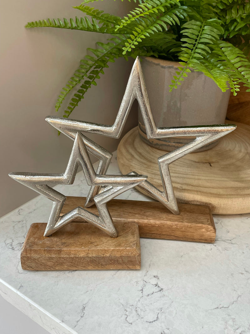 Medium aluminium star on wood block 22cm