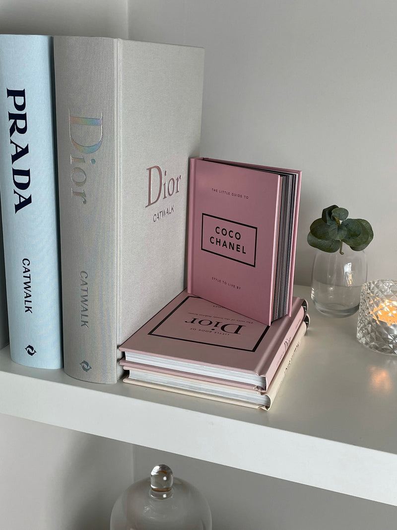 Stack of White Leather Bound Books with Coco Chanel Quote I Dont Car   Vellum Home