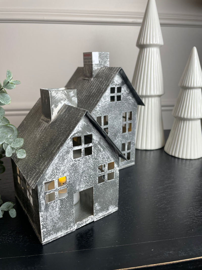 A set of two metal houses candle holders