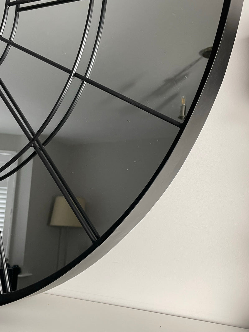 Huge round black metal chunky window mirror