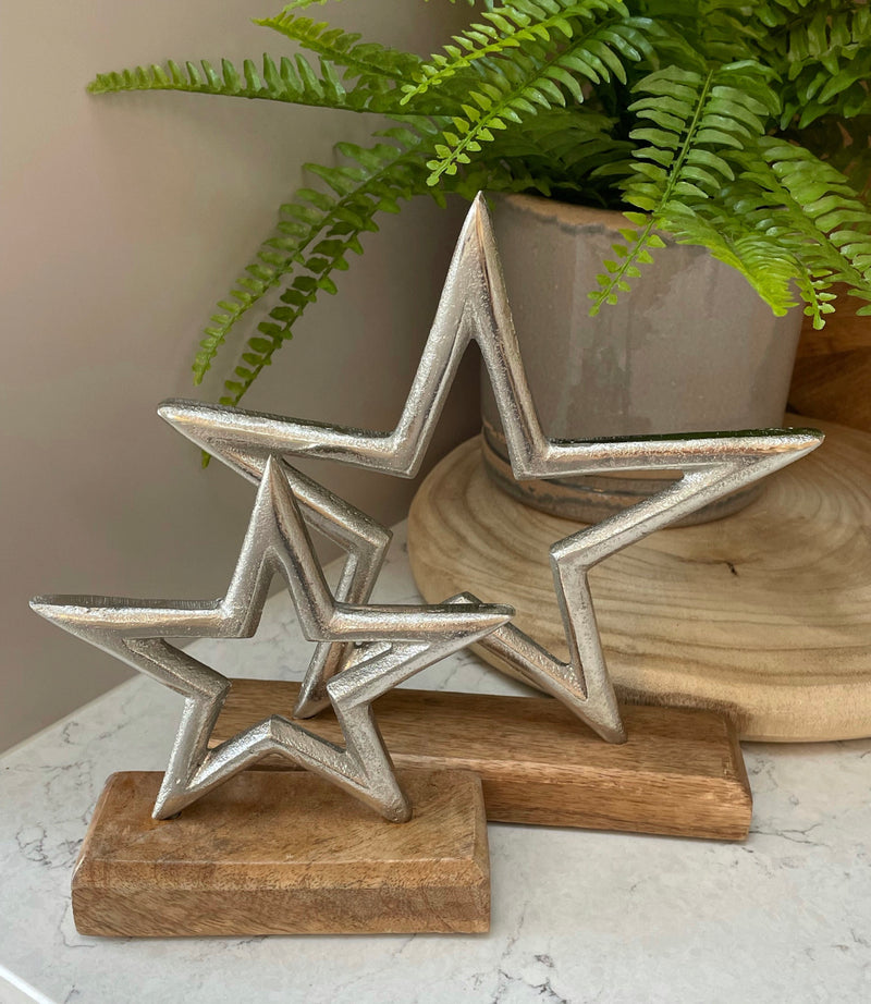 Large aluminium star on wood block