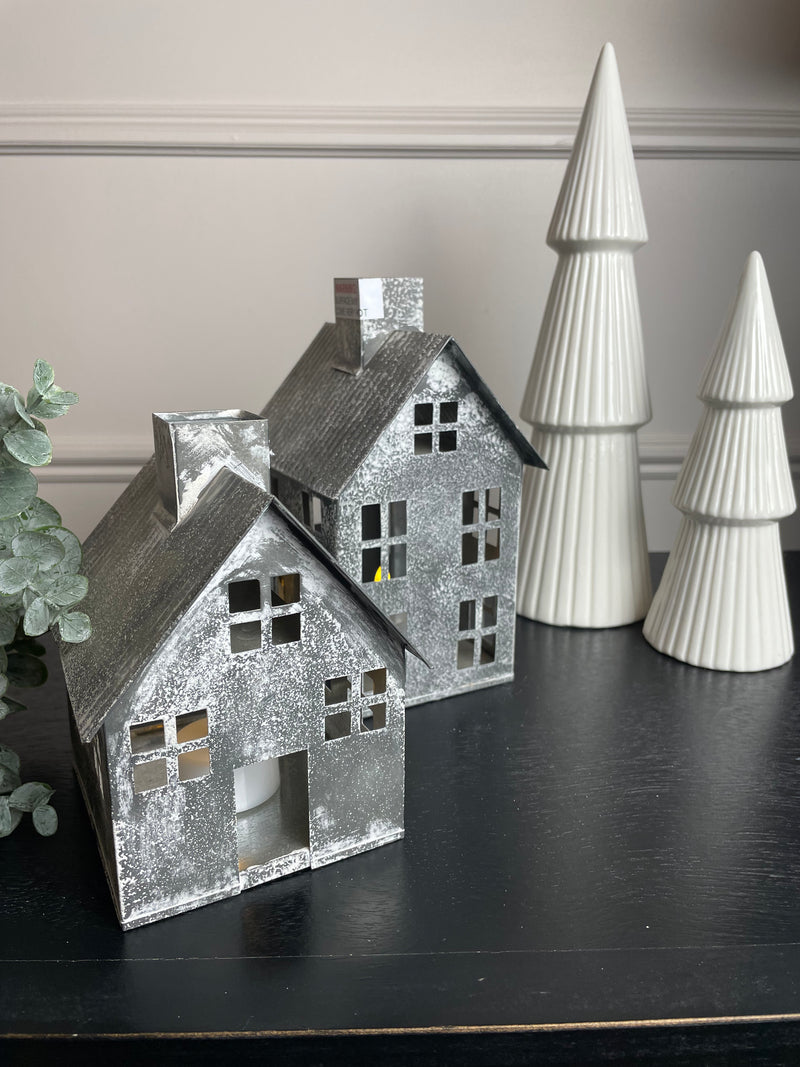 A set of two metal houses candle holders