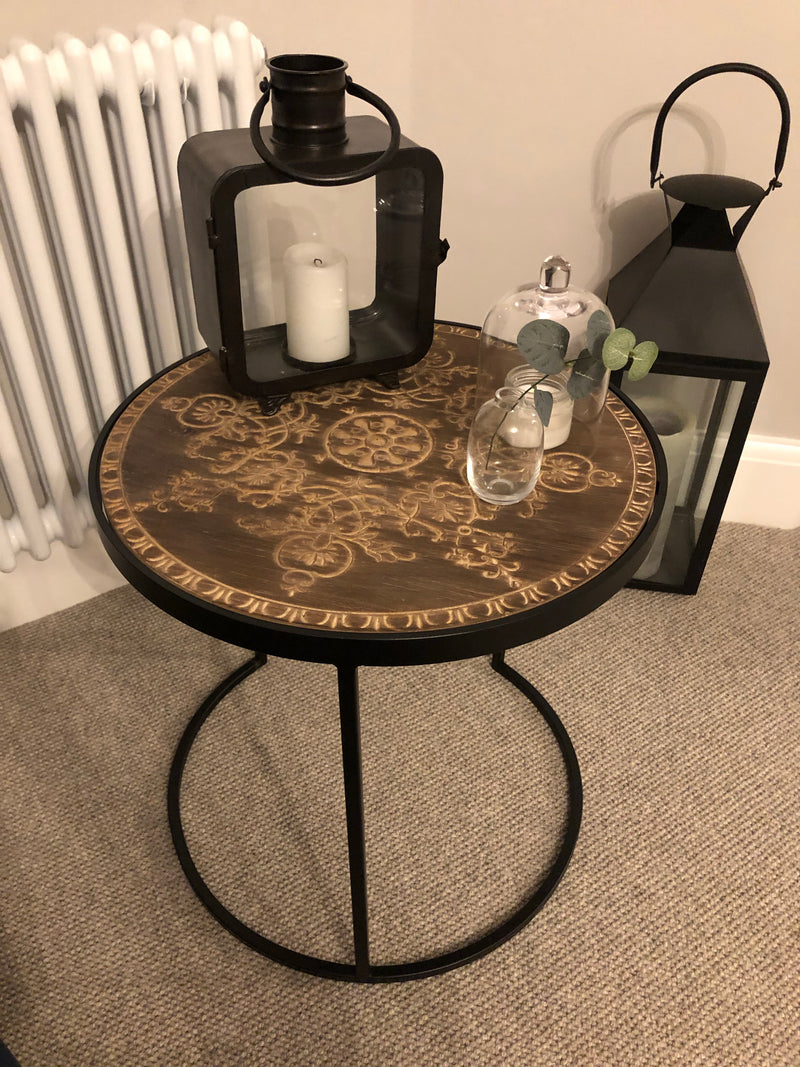 Black metal table with embossed wooden top