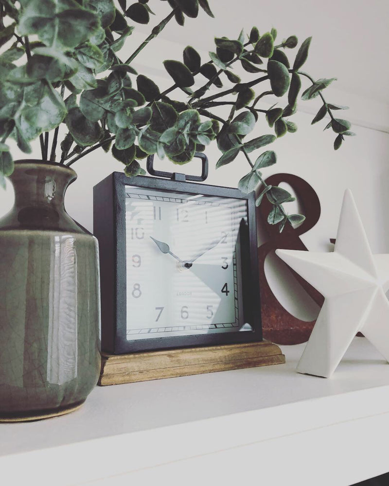 Black wooden based metal clock